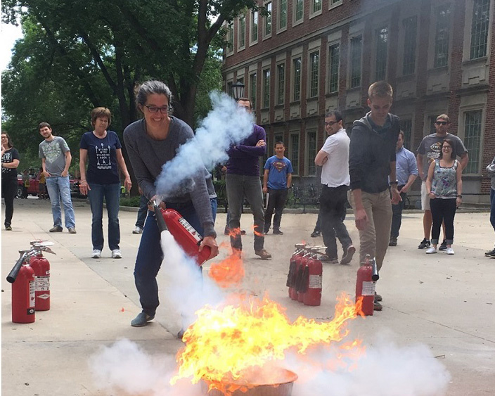 Tori fighting a fire at fire extinguisher safety training